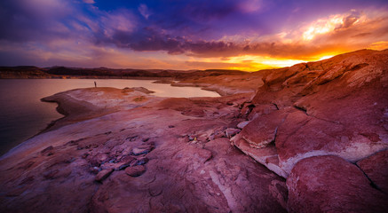 Tourist taking picture with smartphone Lake Powell at Sunset