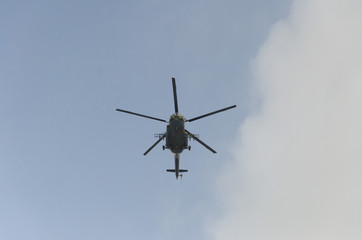 Helicopter flying against the blue sky