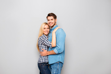 Young couple in love embracing isolated on gray background