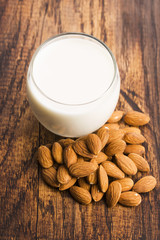 Almond milk with almond on a wooden table