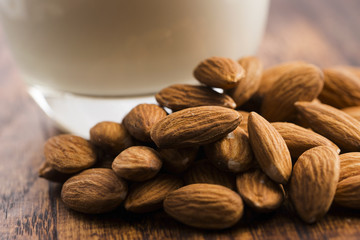 Almond milk with almond on a wooden table