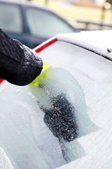 Scraping ice from car window