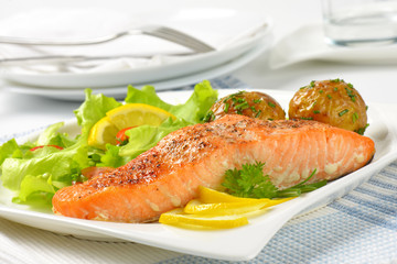 salmon fillet with roasted potatoes and fresh vegetables