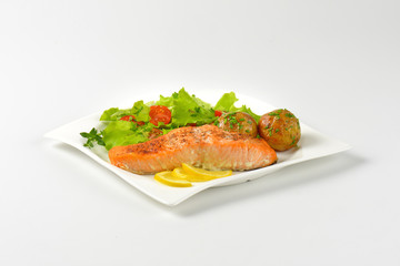 salmon fillet with roasted potatoes and fresh vegetables