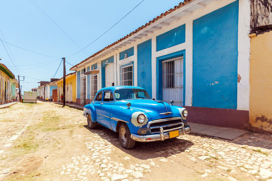 Vintage blue car near Houses in the old town, Trinidad