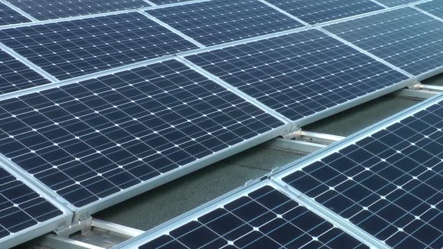 crane shot of a solar panel array on a rooftop