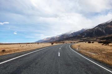 Asphalt road to the National Park Mount Cook in late autumn , South Island, New Zealand.