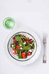 Salad of fresh strawberries,arugula,lettuce,cheese and sesame seeds .healthily cooking concept.selective focus.