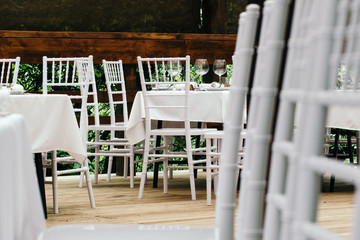 Wedding event. Chiavari chairs on the covered wooden deck.