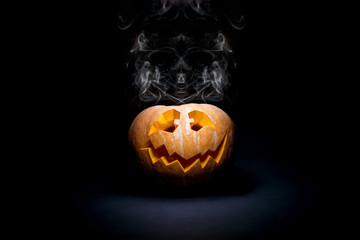 Halloween scary face pumpkin on the black backdrop