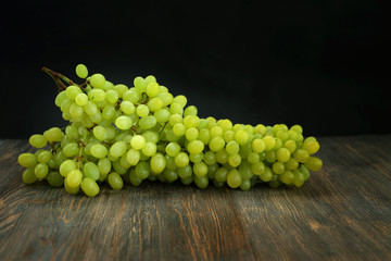 Bunch of grapes on wooden table.