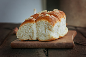 Buns with garlic on a wooden background