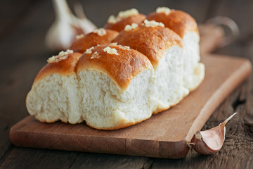 Buns with garlic on a wooden background