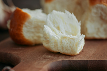 Buns with garlic on a wooden background, close up