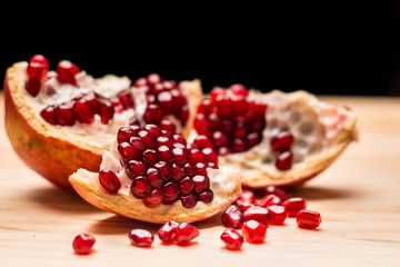 Pomegranade seeds on a wooden table