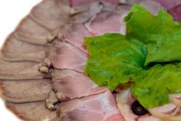 Cold meal of ham and cold smoked meat. The serving of the dinner table snacks. Cold food on the holiday table.