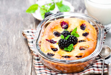Cake  with blackberries on wooden table