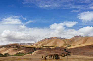 Mountais on the blue cloudy sky. Altay