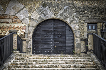 Black wooden door of a castle