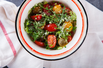 Vegetable salad, mixed cherry tomatoes with Parmesan cheese and arugula.selective focus.