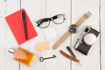 travel concept - set of cool stuff with camera and other things on wooden table