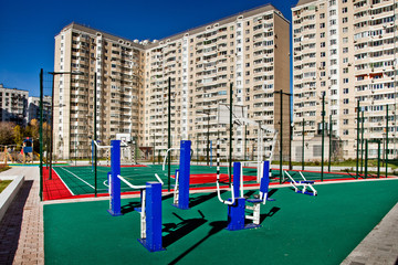 Fototapeta na wymiar Playground with sport fitness equipment in the yard
