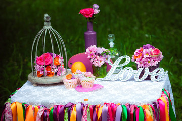 Love wooden sign on the table, wedding decoration with flowers bouquets