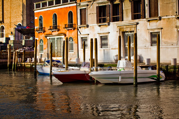 Boats on Venetian canals, urban Venice city view in Italy