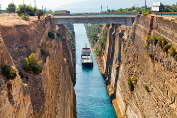 Ship cross The Corinth Canal that connects the Gulf of Corinth with the Saronic Gulf in the Aegean...