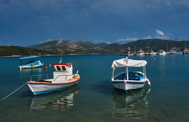 Fototapeta na wymiar Boats and motorboats in the harbor on the island of Lefkada.