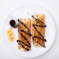 Pancakes with banana and chocolate topping.selective focus.