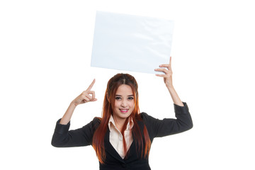 Young Asian business woman point to  blank sign.