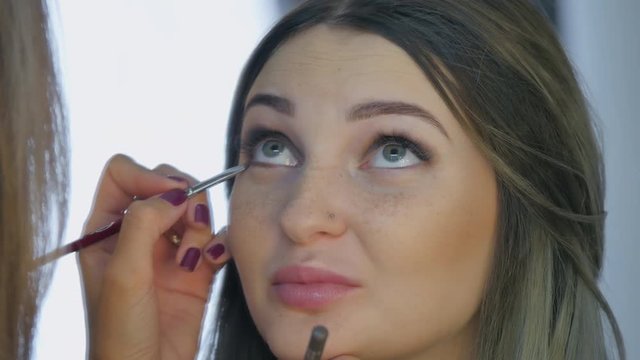 Beautiful girl doing makeup