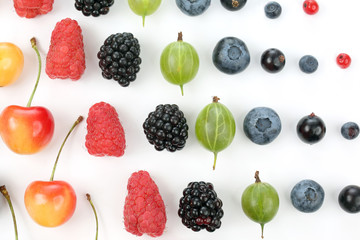 different juicy berries are laid out in rows on a white backgrou