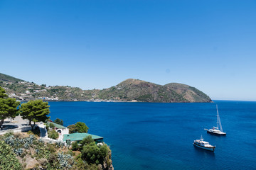 Fototapeta na wymiar Boats on the Blue Sea, Lipari, Messina, Sicily, italy