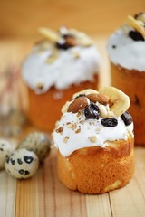 Easter composition with quail eggs nuts dried fruits holiday cake and willow branches on wooden table