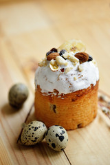 Easter composition with quail eggs nuts dried fruits holiday cake and willow branches on wooden table