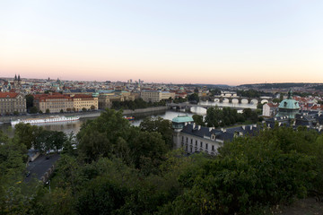Fototapeta na wymiar Evening Prague City with its Bridges and Towers above River Vltava, Czech Republic