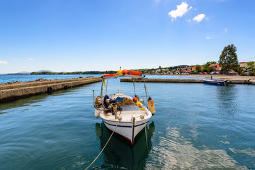 Typical fishing boat and crystal emerald sea water in Ipsos on Corfu island. Greece.