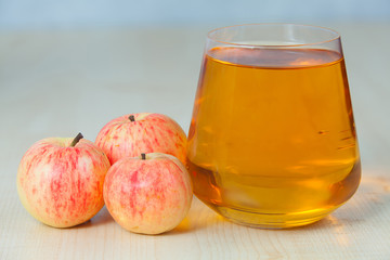 Delicious fresh squeezed apple juice in  transparent glass