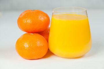 Delicious fresh squeezed tangerine juice in  transparent glass