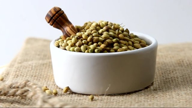 Rotating coriander seeds in a bowl