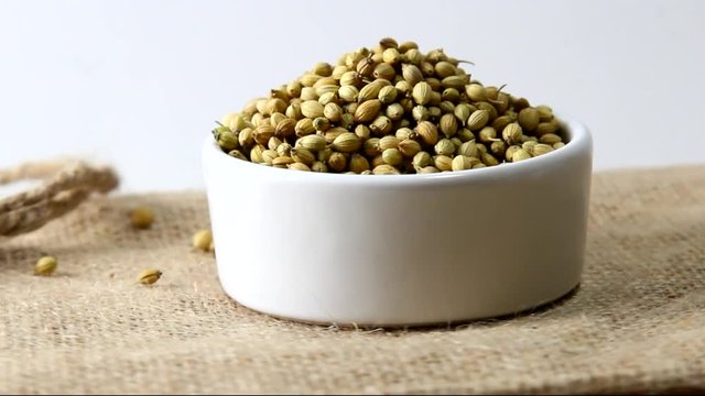 Rotating coriander seeds in a bowl