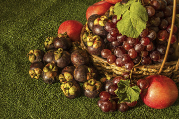 Still life for with autumn fruits grape apple and mangosteen