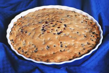 Homemade blueberry pie standing on a blue tablecloth