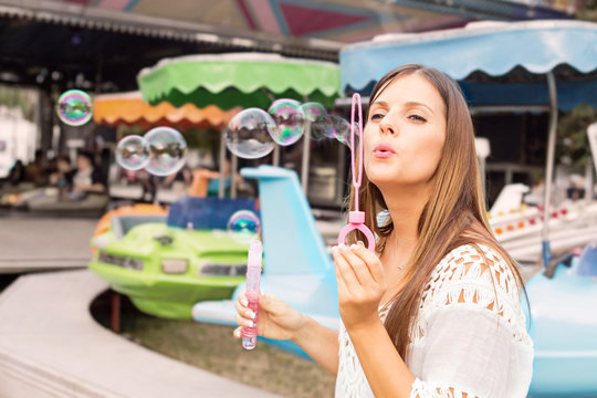 young woman blowing bubbles