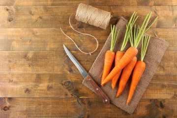 Fresh carrots on wooden background