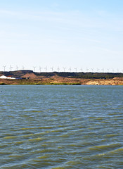 The Tranquera reservoir with windmills in the background, Spain