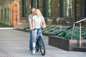 Fototapeta premium Happy couple with bicycle on street