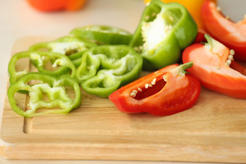 Pepper slices on wooden cutting board